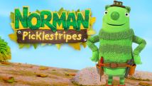 A friendly, green-striped creature wearing a tool belt is standing on a wooden log with his hands on his hips.